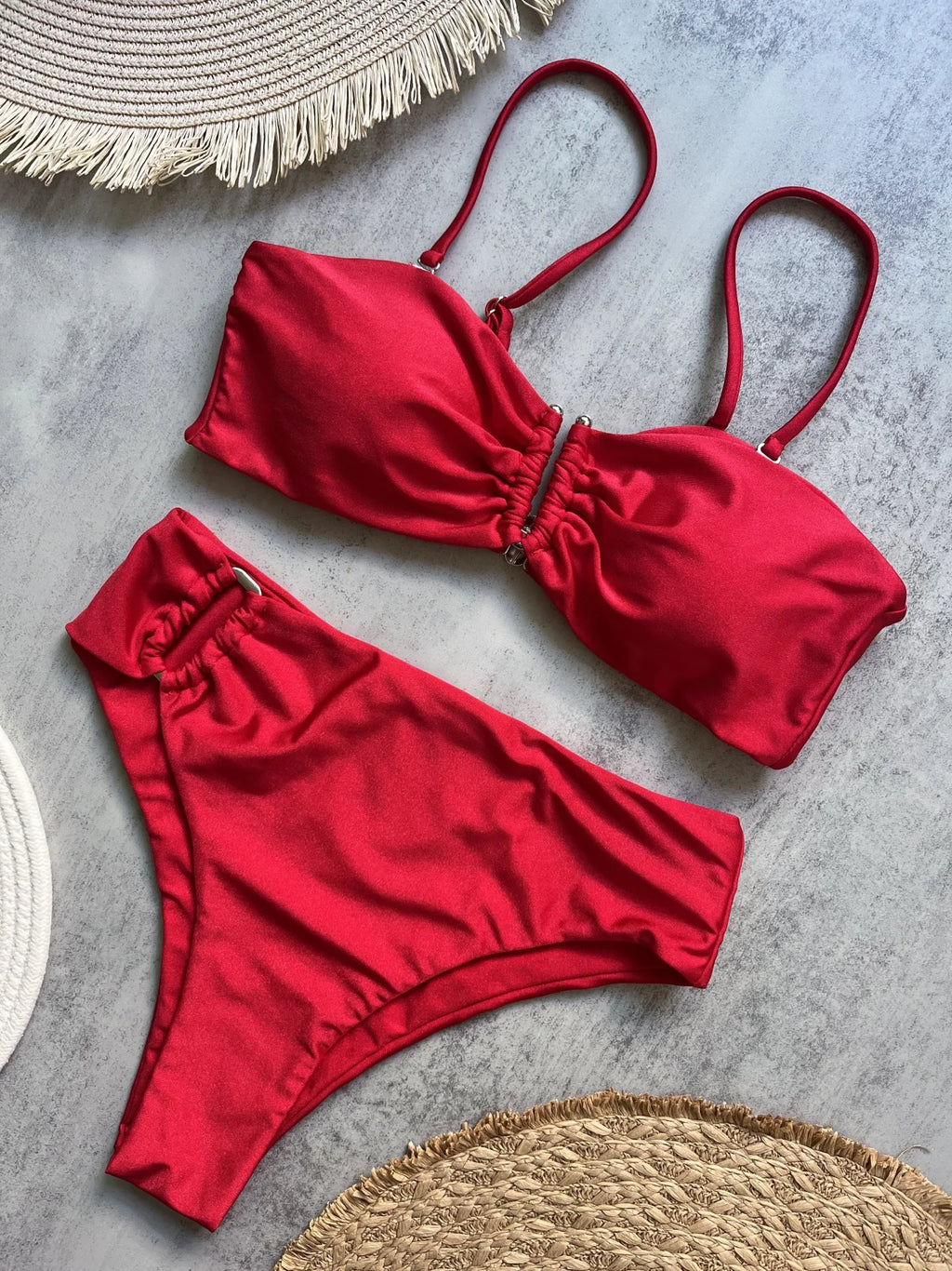 Red bandeau push up bikini set with ruched center front on marble surface