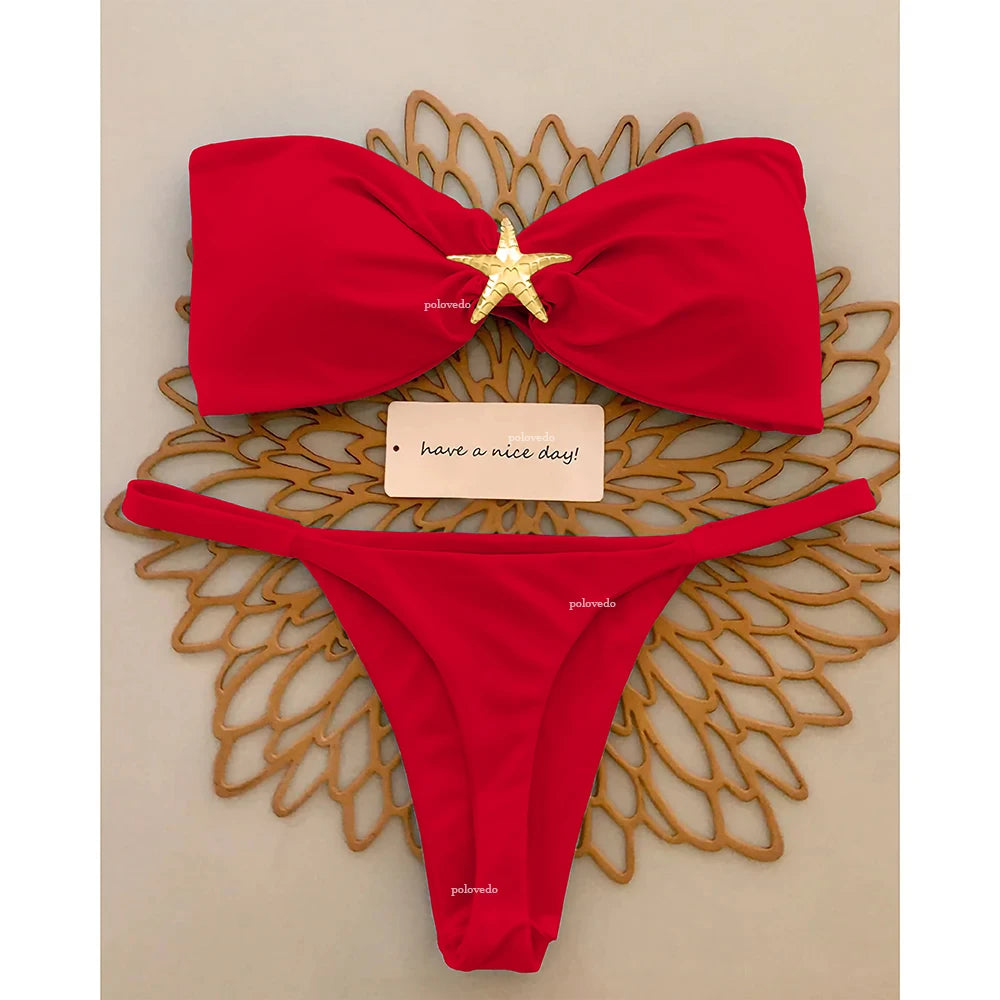 Red knot bandeau bikini top with gold starfish accent and micro thong bottom, flat lay