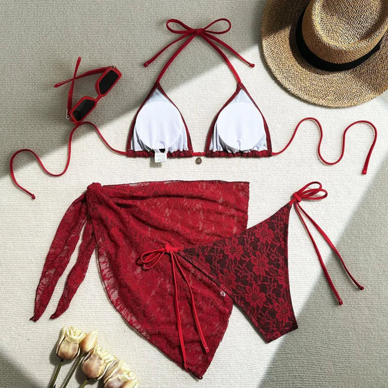 red lace bikini set laid flat with cover up and halter top