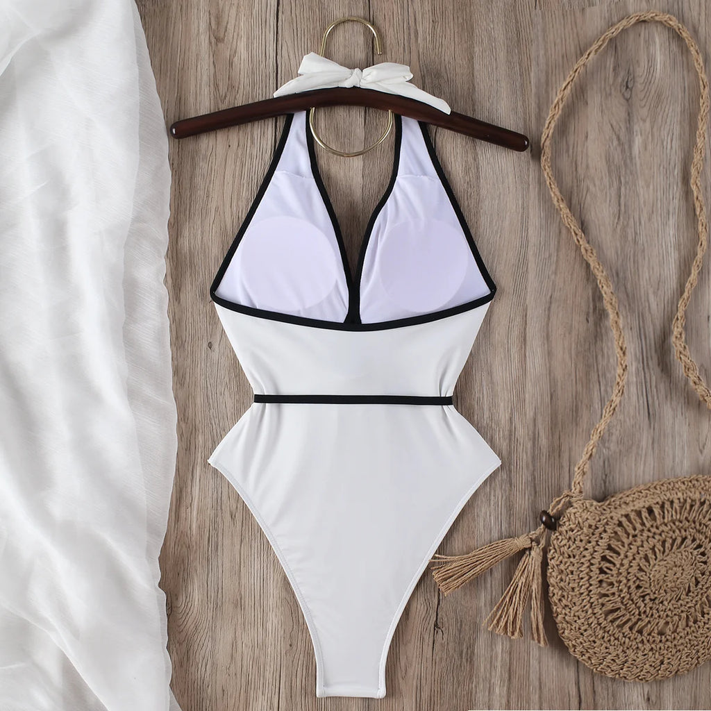 ivory halter bikini top and tie waist bottoms laid flat with black trim