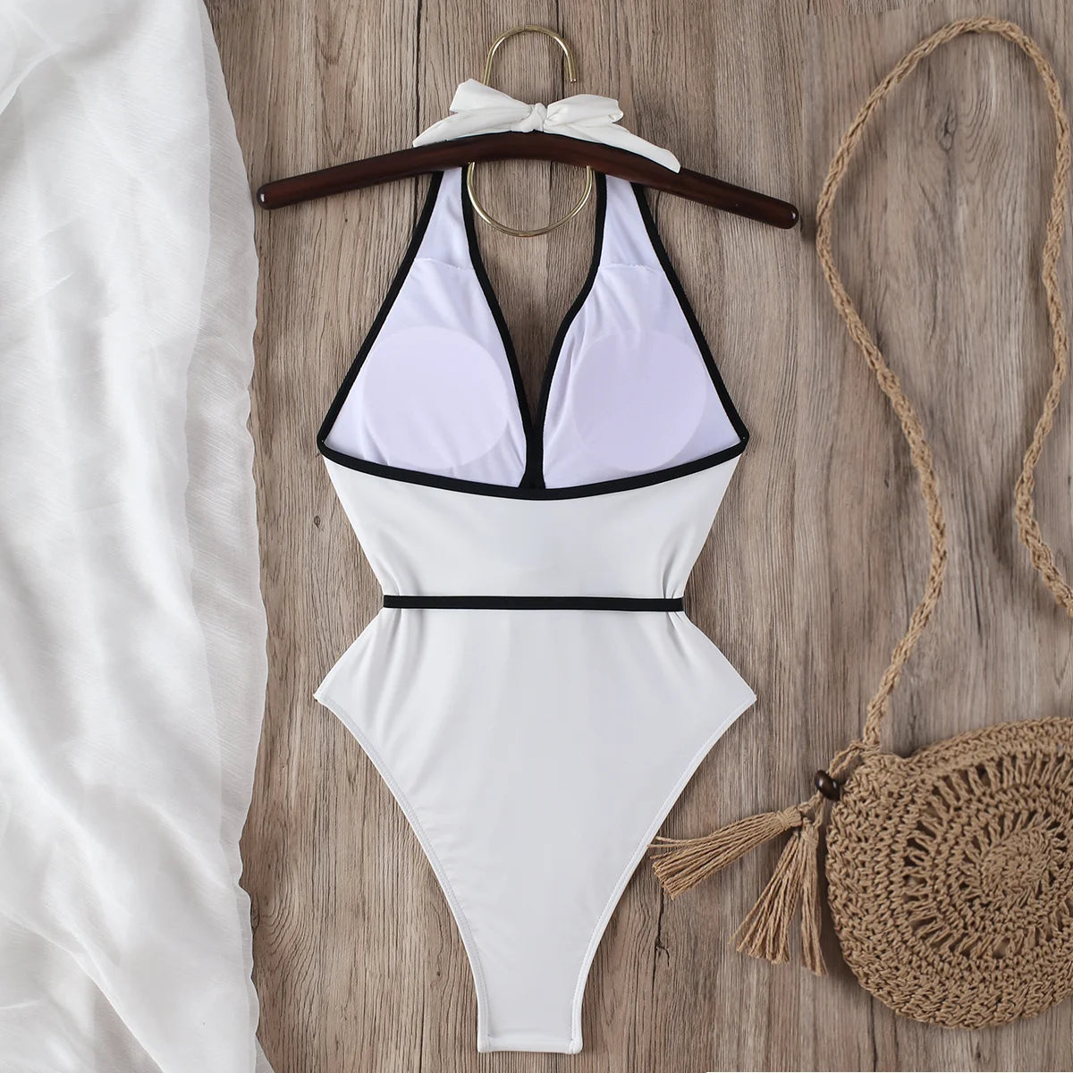ivory halter bikini top and tie waist bottoms laid flat with black trim