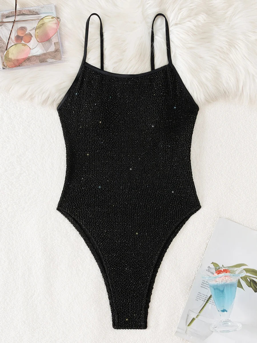 Black sparkling wrinkled high-leg one-piece swimsuit for women with thin spaghetti straps and glittery texture