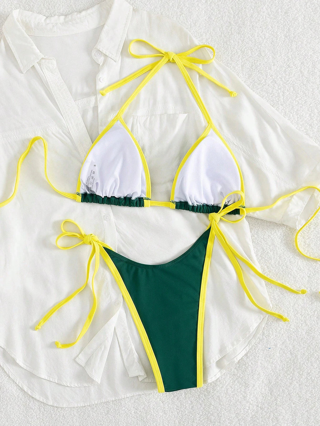 white triangle halter bikini top with yellow contrast straps and green trim paired with green micro thong bottom