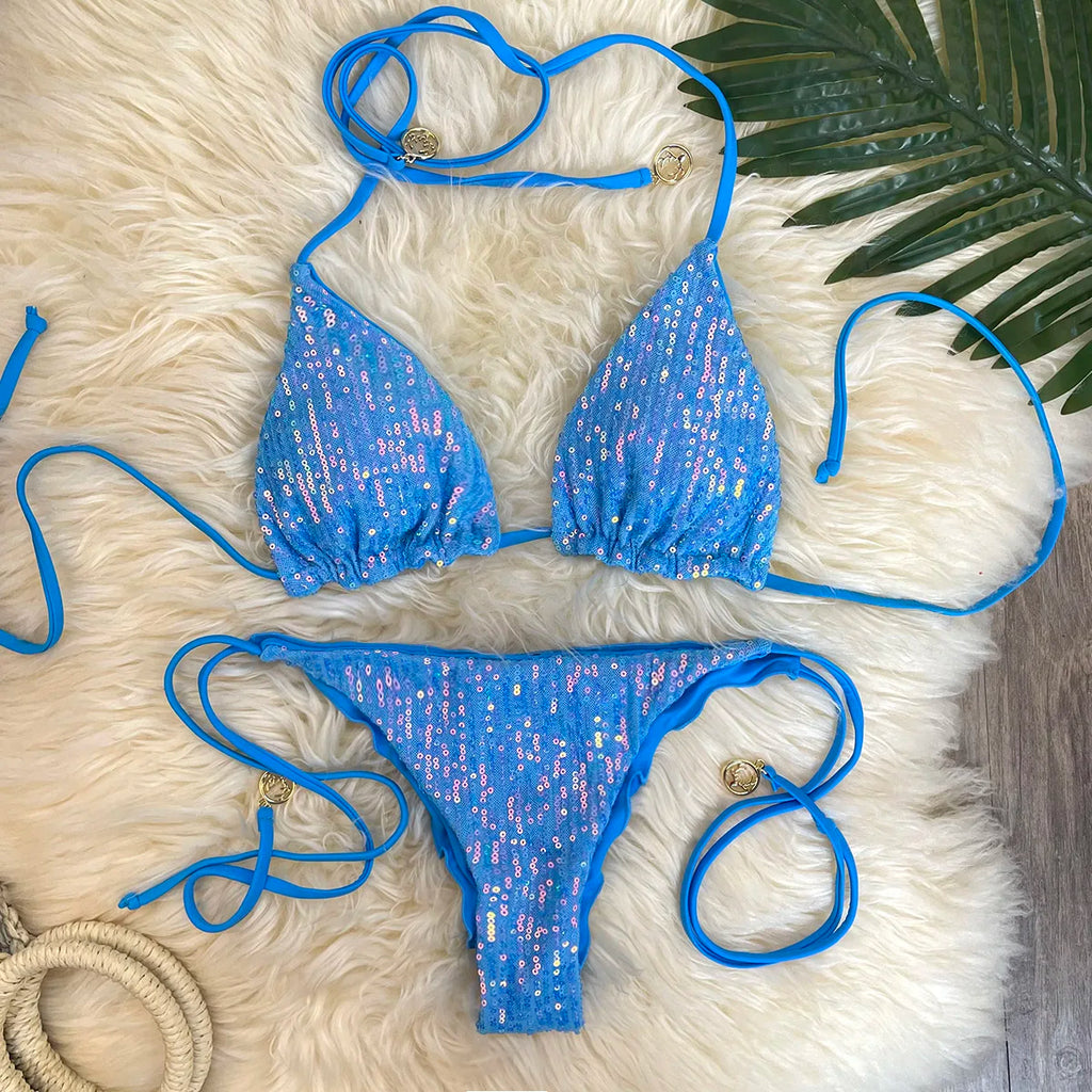 Blue sequin triangle top and sequin ruffle thong with tie sides on white fur rug