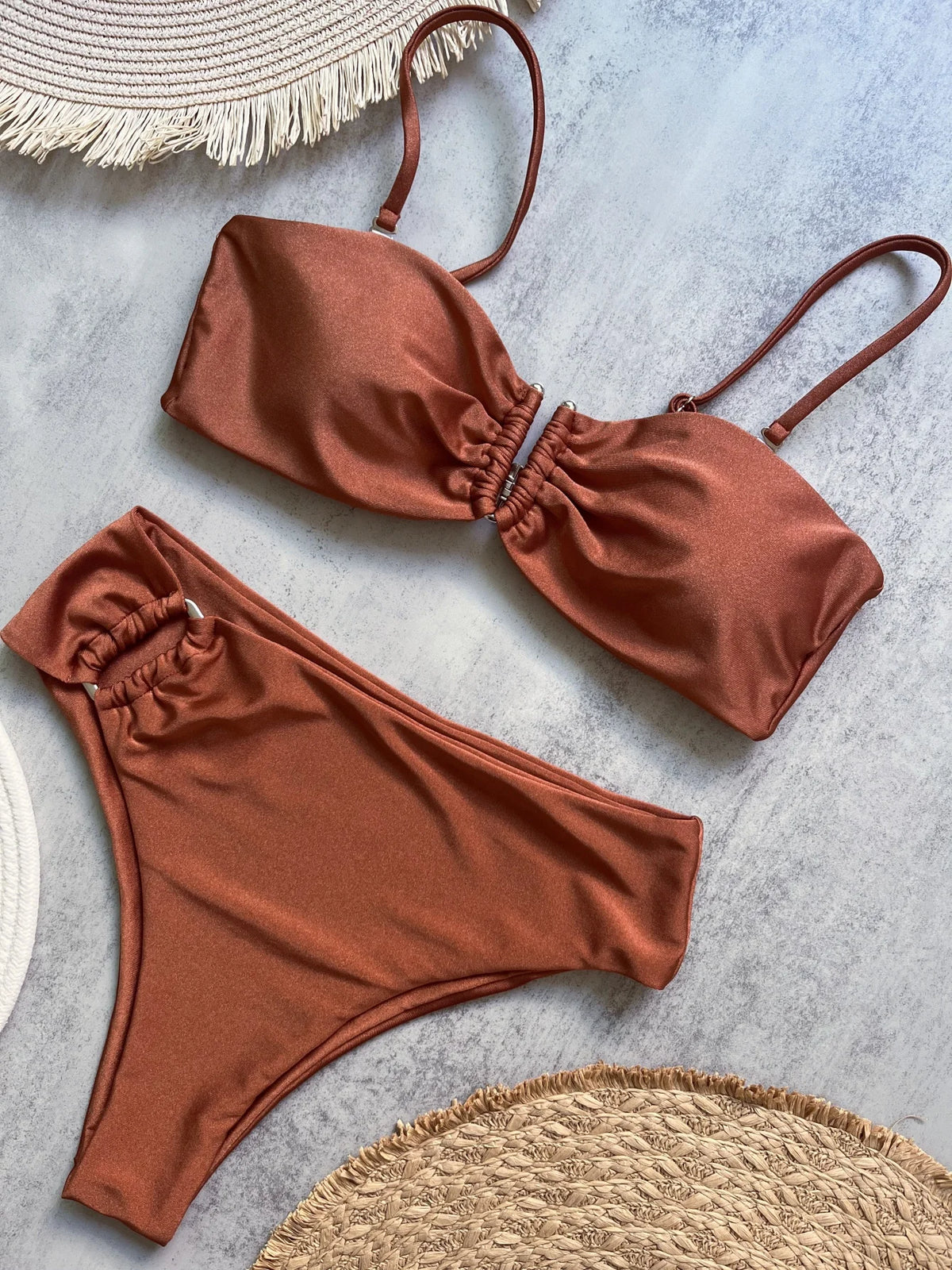 Rust bandeau push up bikini set with ruched center front on marble surface