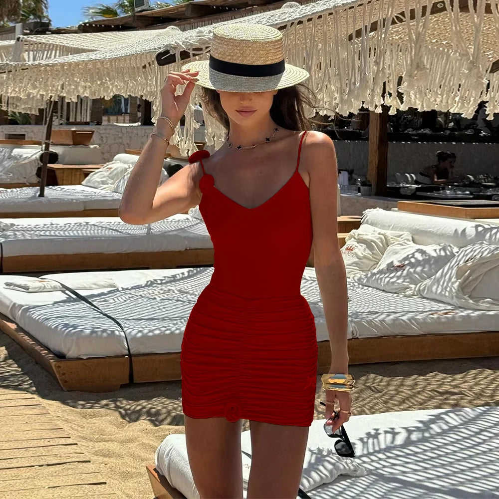woman in red ruched mini dress one piece swimsuit on the beach