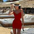 woman in red ruched mini dress one piece swimsuit on the beach