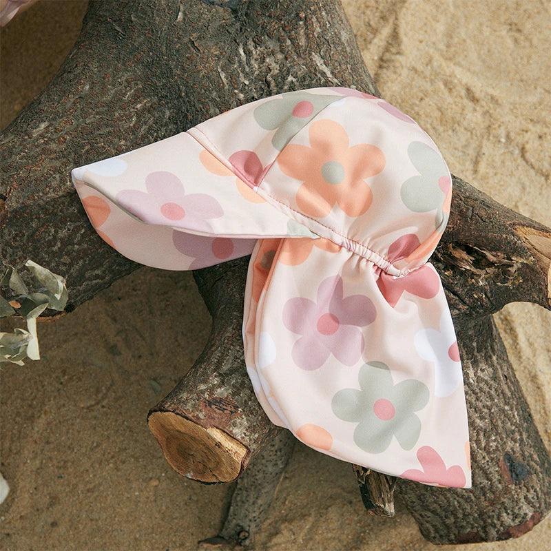 Toddler floral tropical long sleeve swimsuit with a soft pink sun hat featuring a peach lavender and mint floral pattern