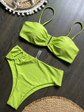 Lime green bandeau push up bikini set flat lay on wooden table