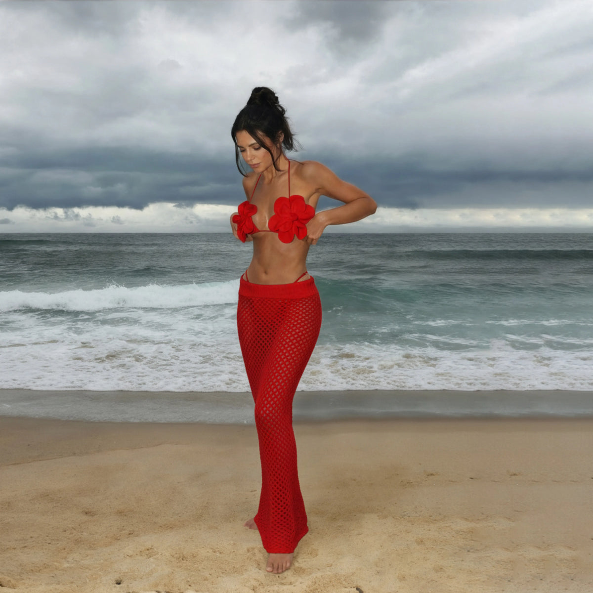 Model wearing the red floral applique bikini with a sheer mesh red maxi skirt