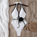 ivory halter bikini set with black contrast trim on a hanger