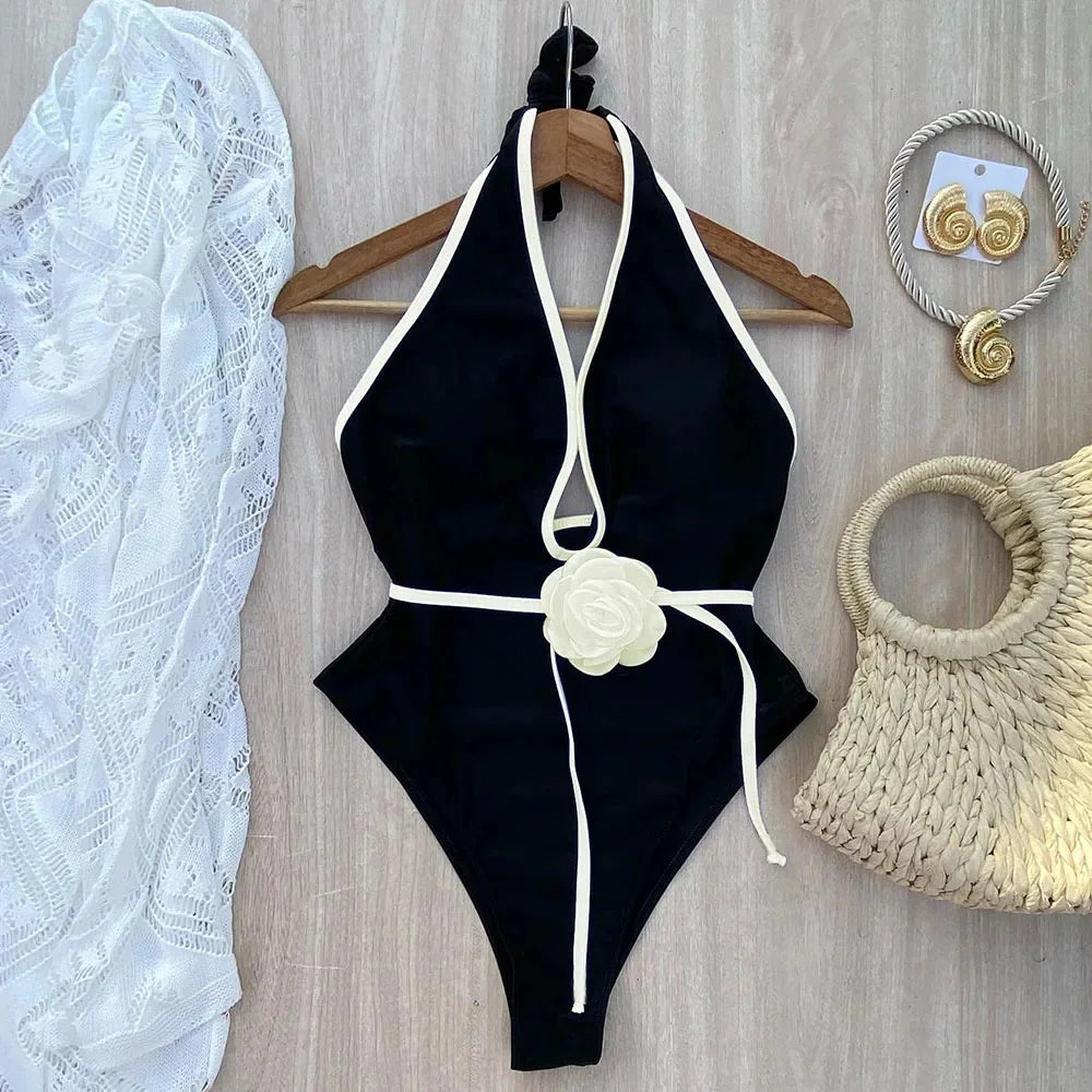 black halter bikini set with ivory contrast trim on a hanger