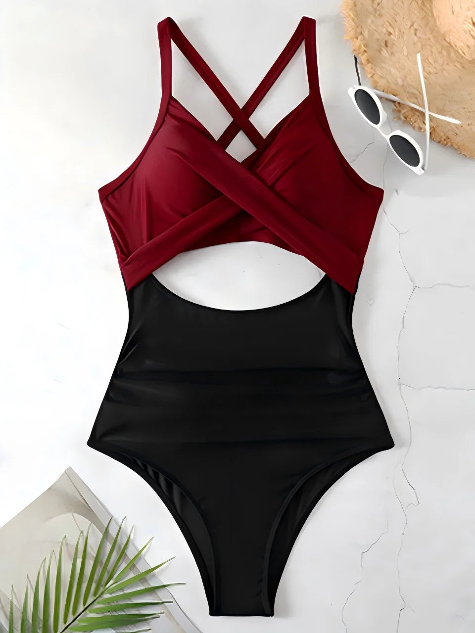wine red cross strap top with black body ruched one piece swimsuit laid flat