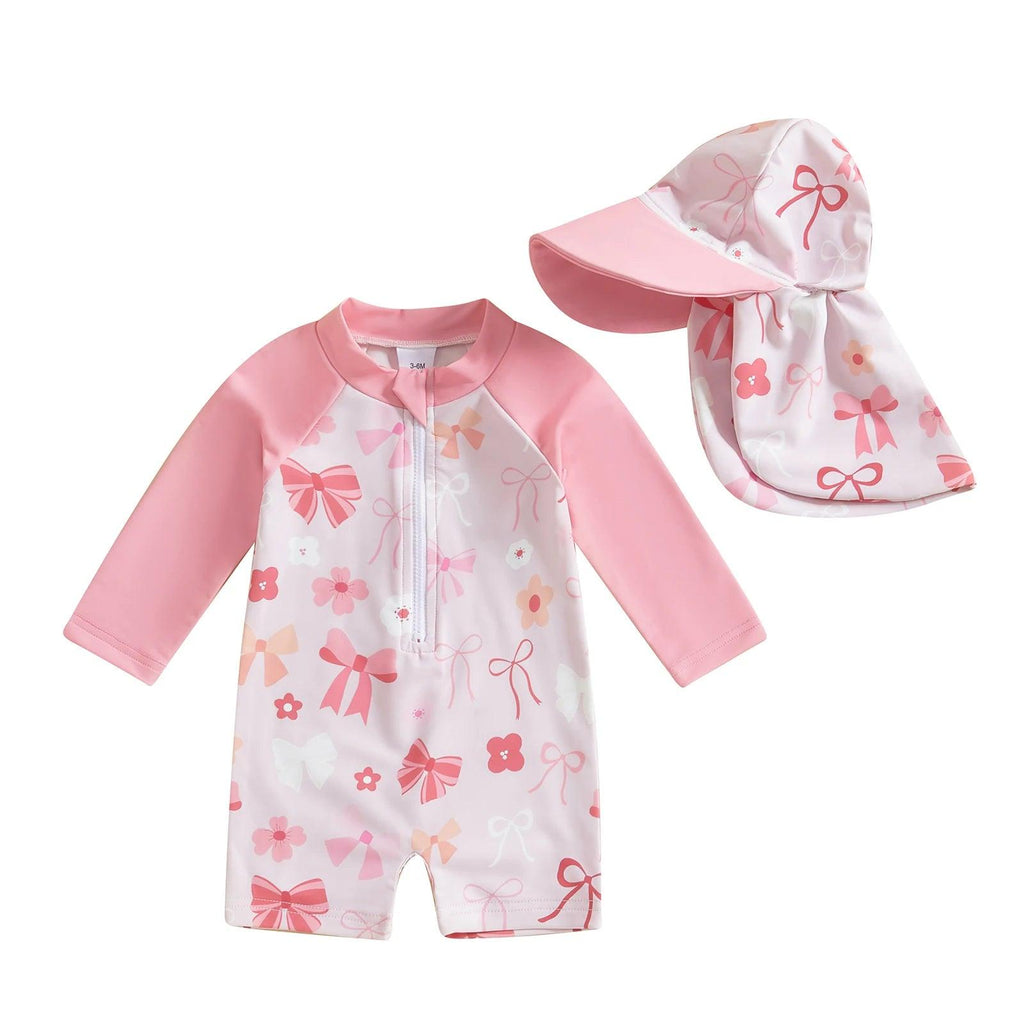 Toddler pink and white long-sleeve floral swimsuit with bow detail and matching sun hat for tropical sun protection