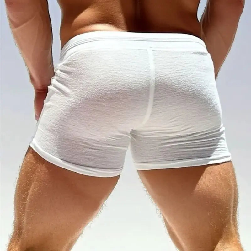 Back view of white sheer mesh men's shorts with drawstring waistband and mid-thigh length