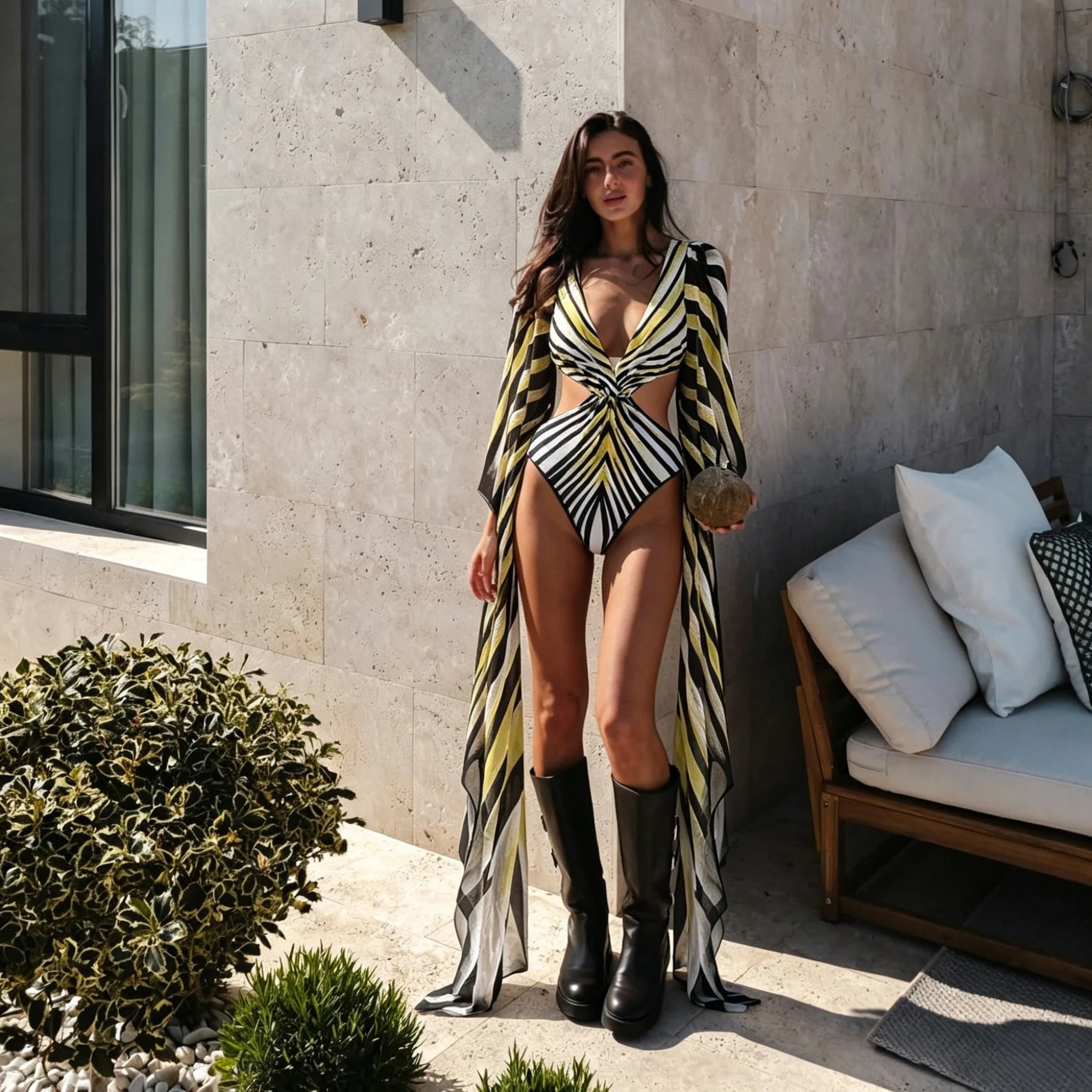 Model in a yellow black and white chevron print one piece swimsuit with matching long cover up