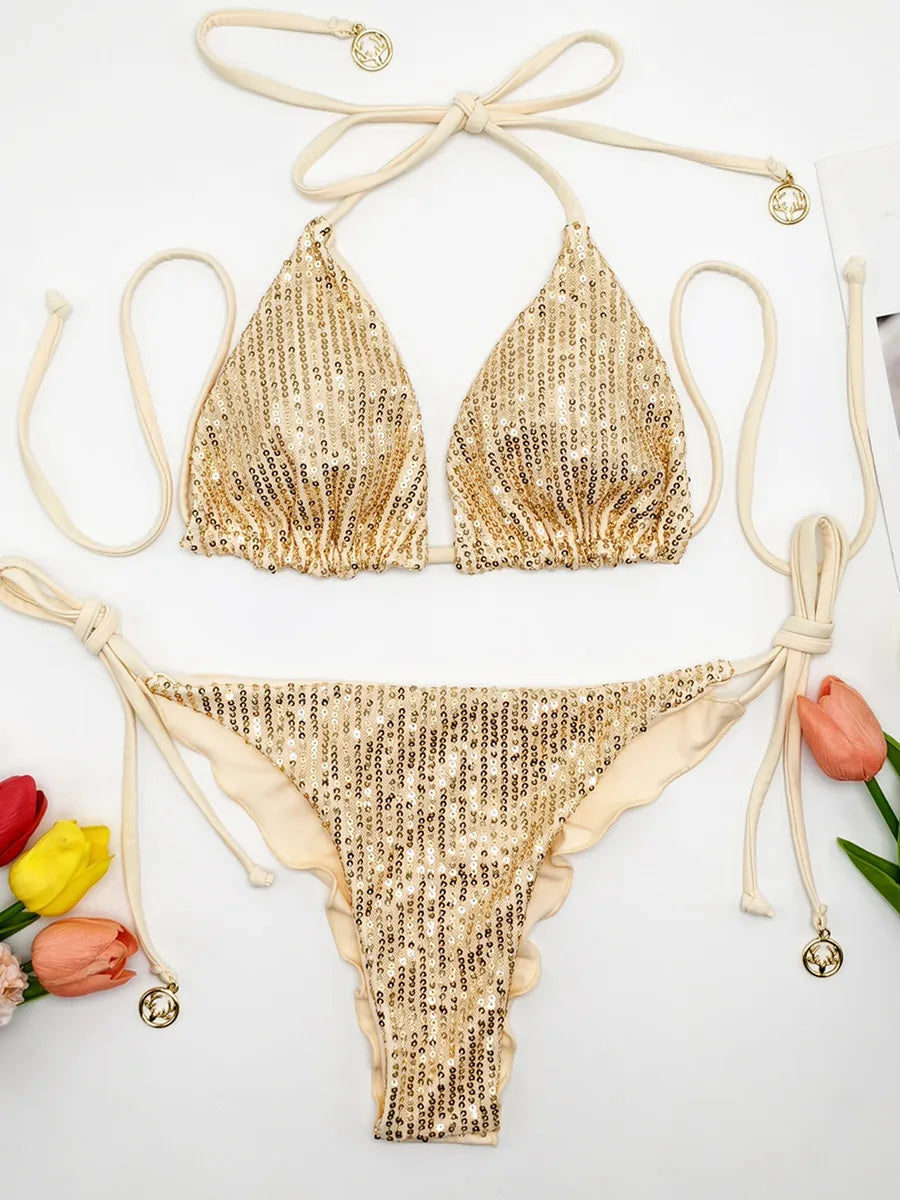 Champagne gold sequin triangle bikini set with ruffle thong on white background with tulips