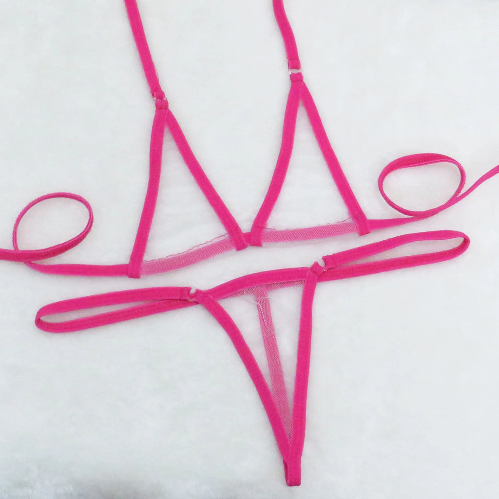 Hot pink sheer mesh triangle top and string thong bottom with long tie straps on white towel