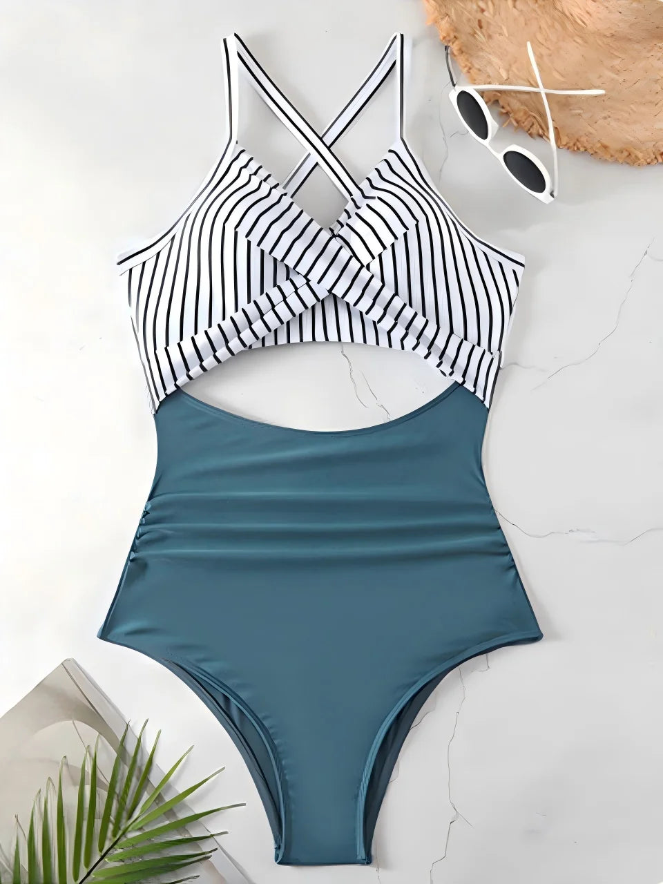 blue striped cross strap top with black body one piece swimsuit laid flat