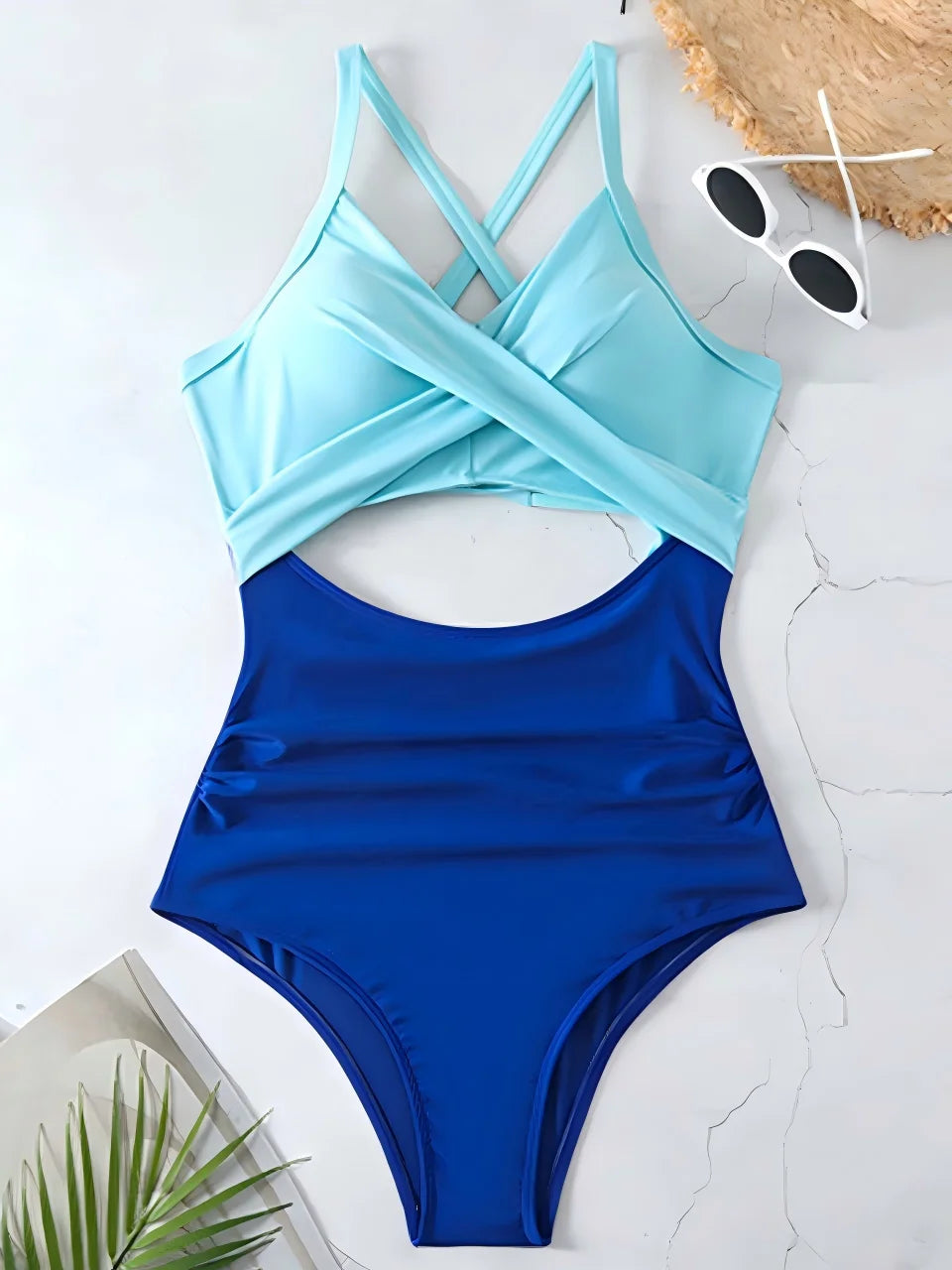 sky blue cross strap top with royal blue body one piece swimsuit laid flat
