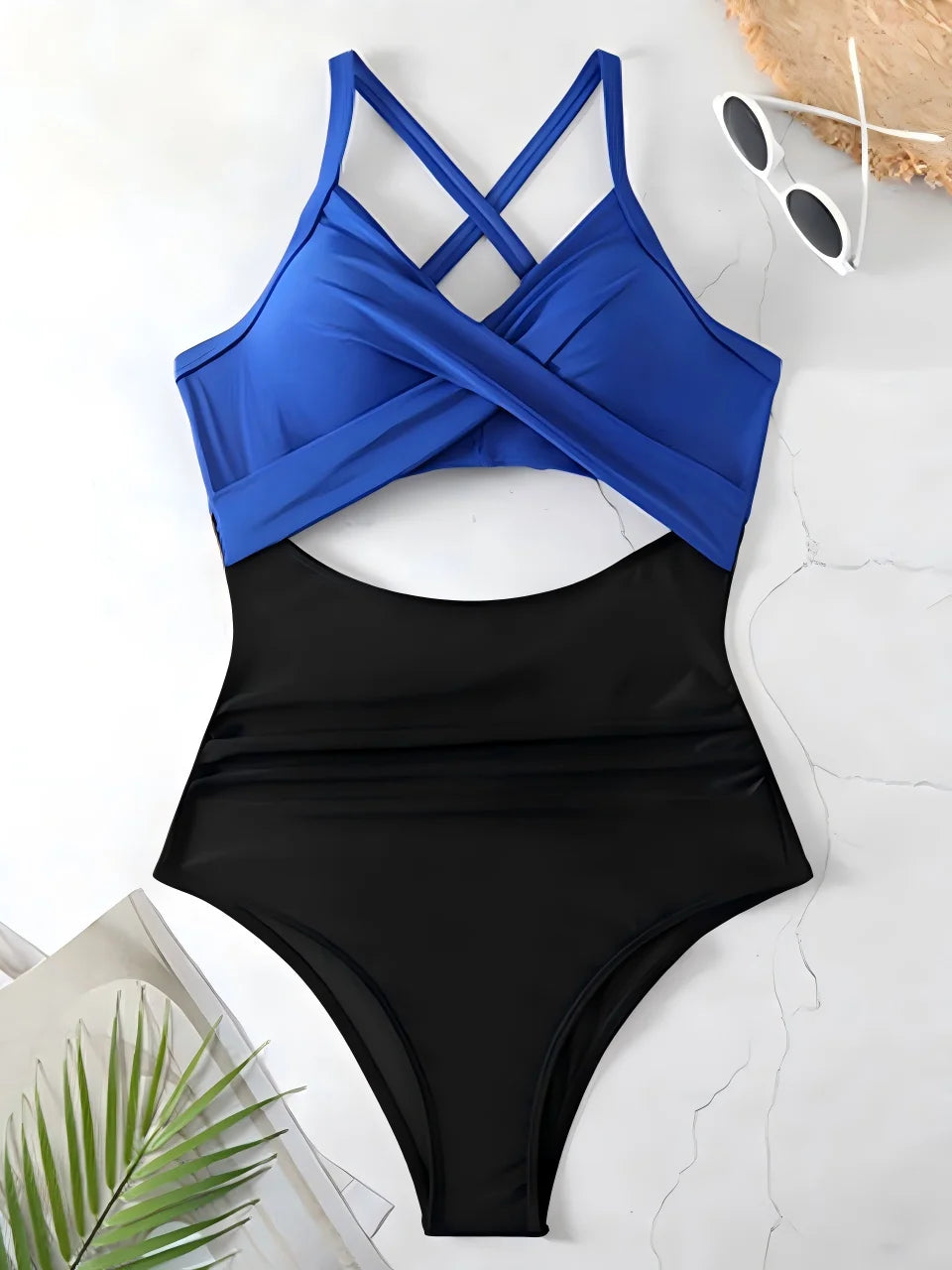 royal blue cross strap top with black body ruched one piece swimsuit laid flat