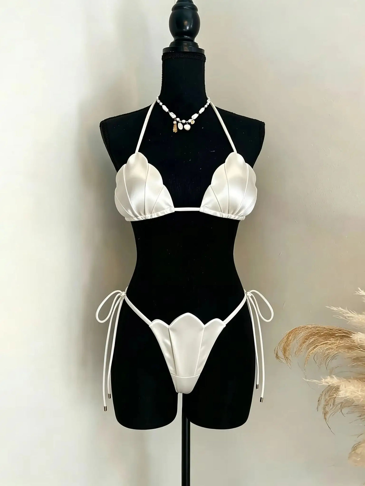 Cream scalloped bikini set displayed on a mannequin in studio lighting