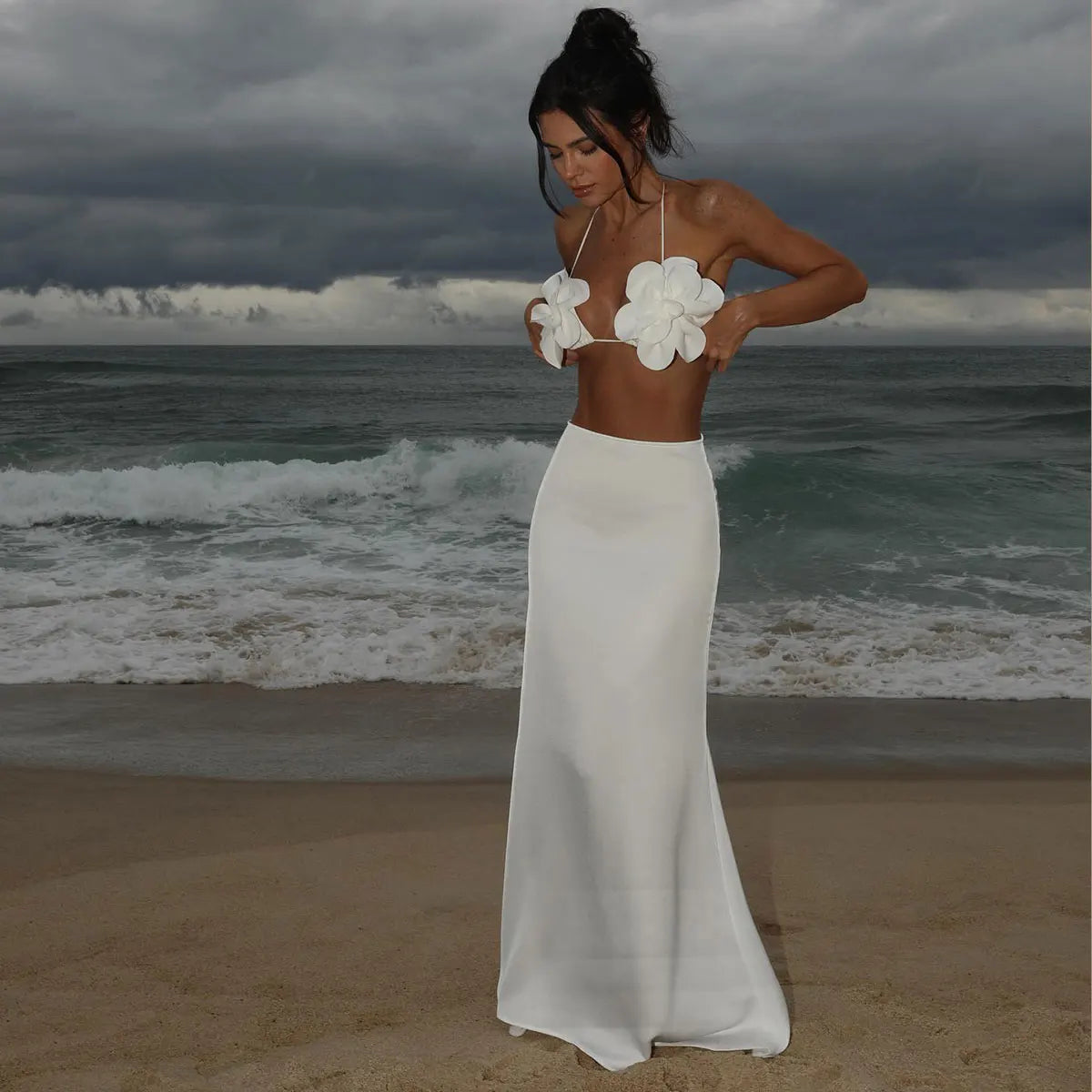 Model in the white floral applique bikini with a smooth solid white maxi skirt at the beach