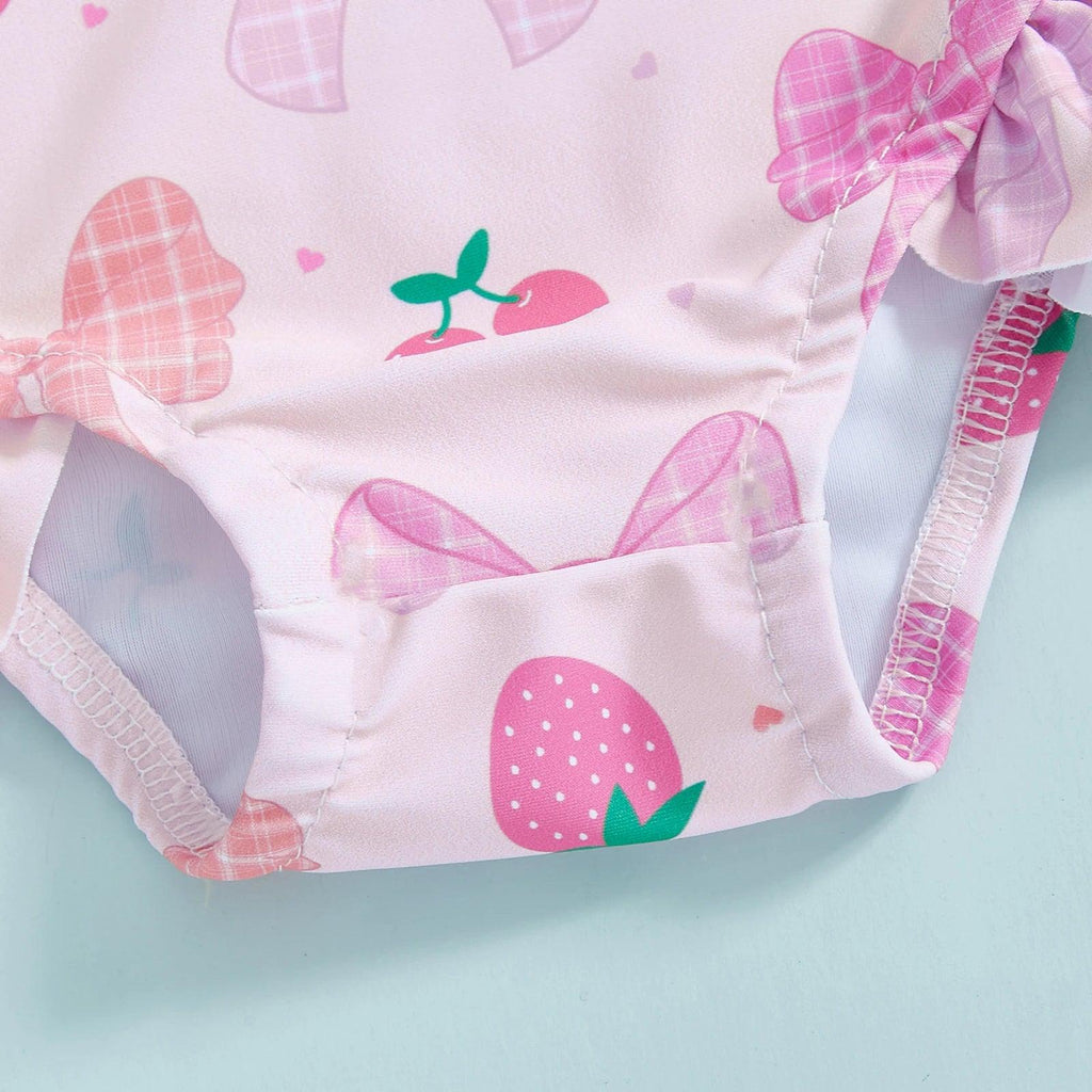 Toddler girls long‑sleeve rash guard swimsuit in pink strawberry print with plaid bow and white polka dot details