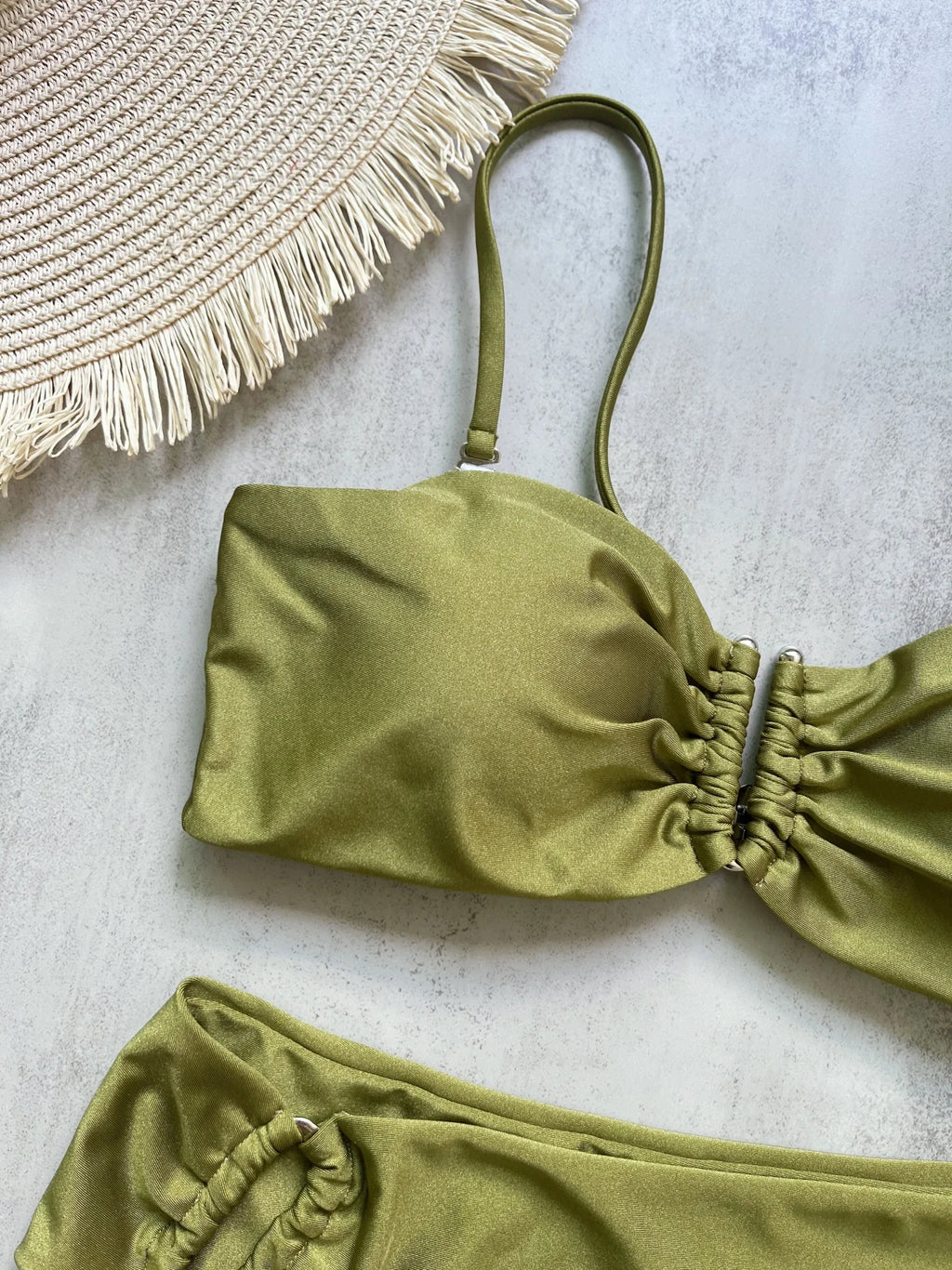 Close-up of olive green bandeau bikini top showing center ruching and tie strap