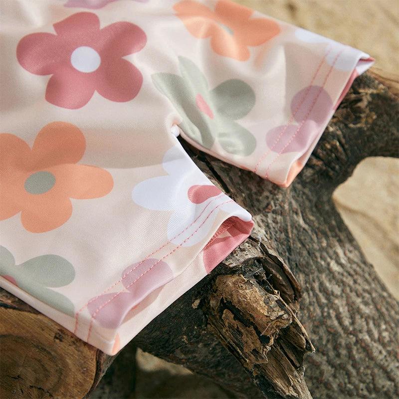 Toddler floral tropical long sleeve swimsuit top with sun hat in soft pastel colors and playful floral pattern