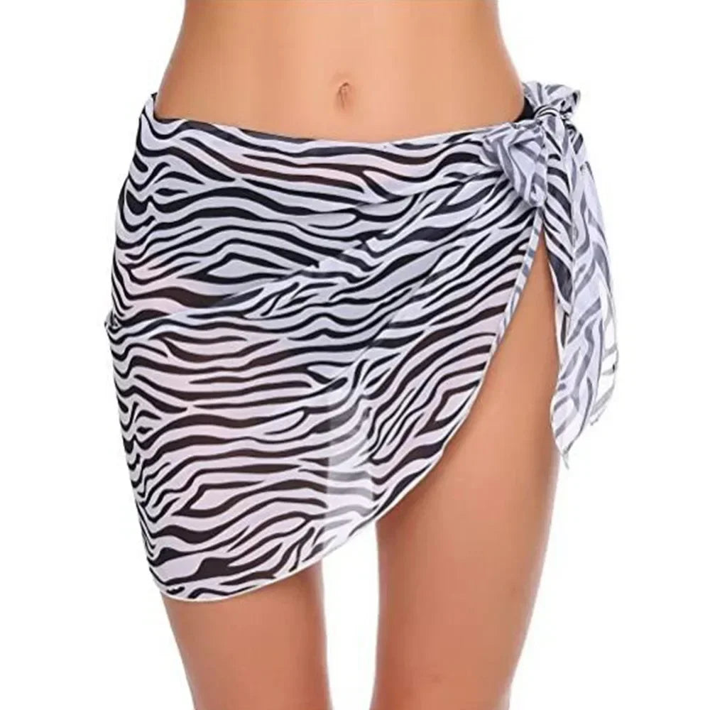 model wearing a zebra print chiffon sarong wrap tied at the side
