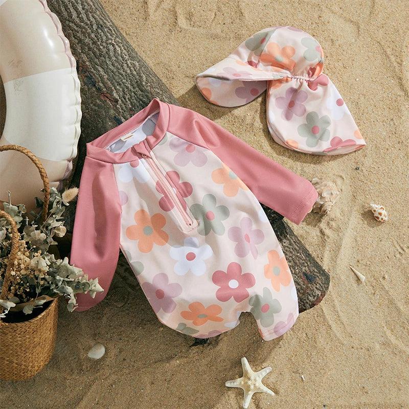 Toddler pink and white floral long-sleeve one-piece swimsuit with sun hat for tropical sun protection