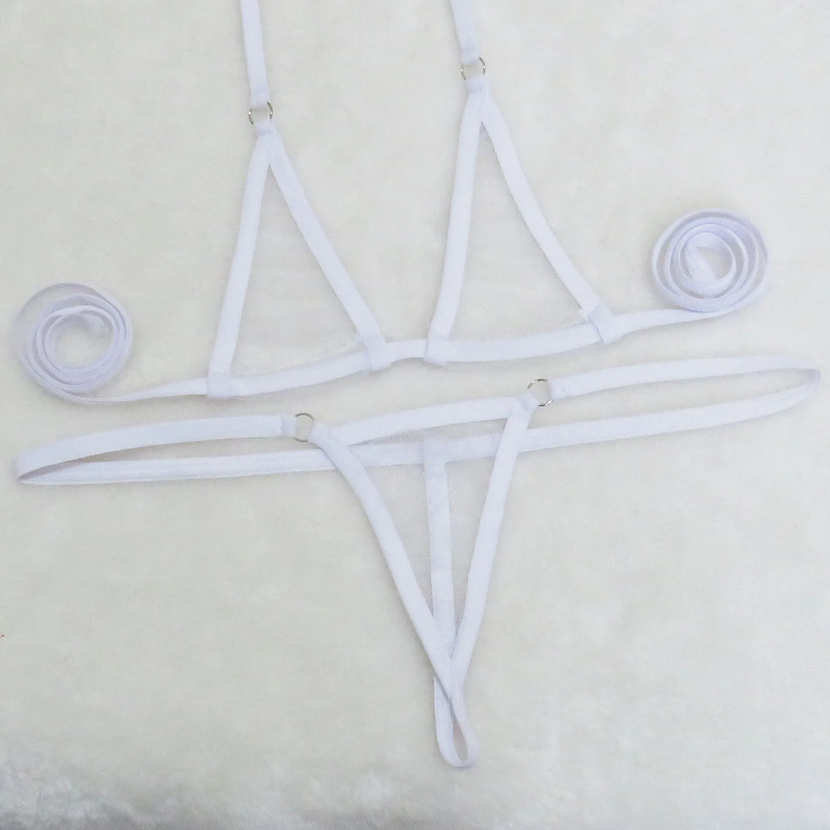White sheer mesh micro bikini set with tie neck and side straps on white towel