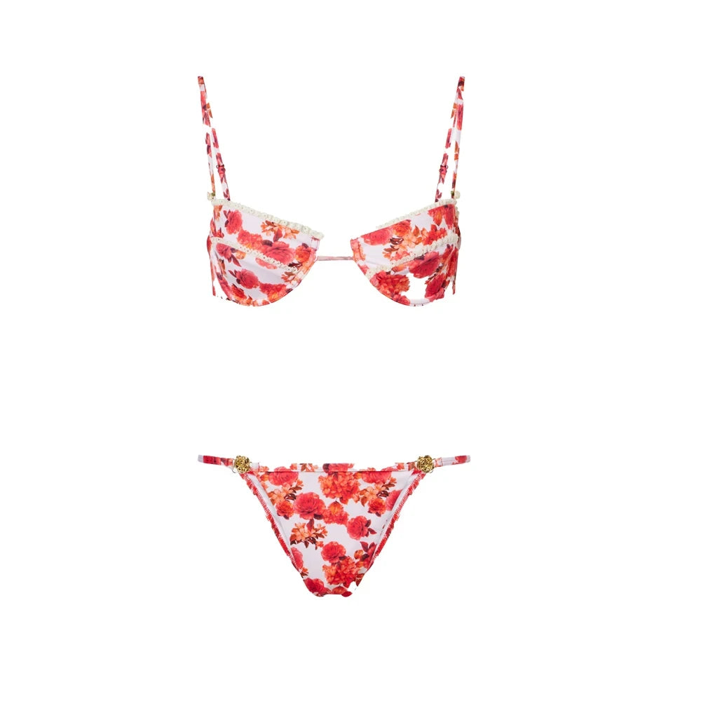 Mixed red floral triangle top and solid coral thong bottom micro bikini flat lay