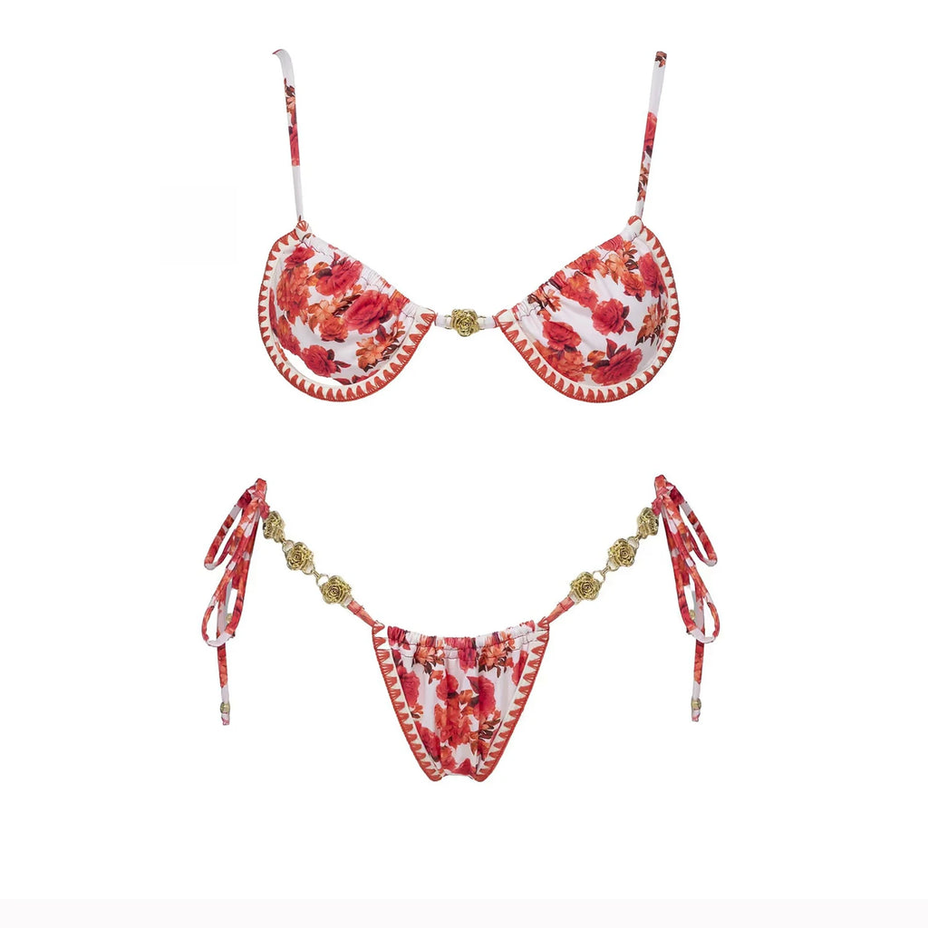 Strappy red floral micro bikini top and beaded thong bottom with tie straps flat lay