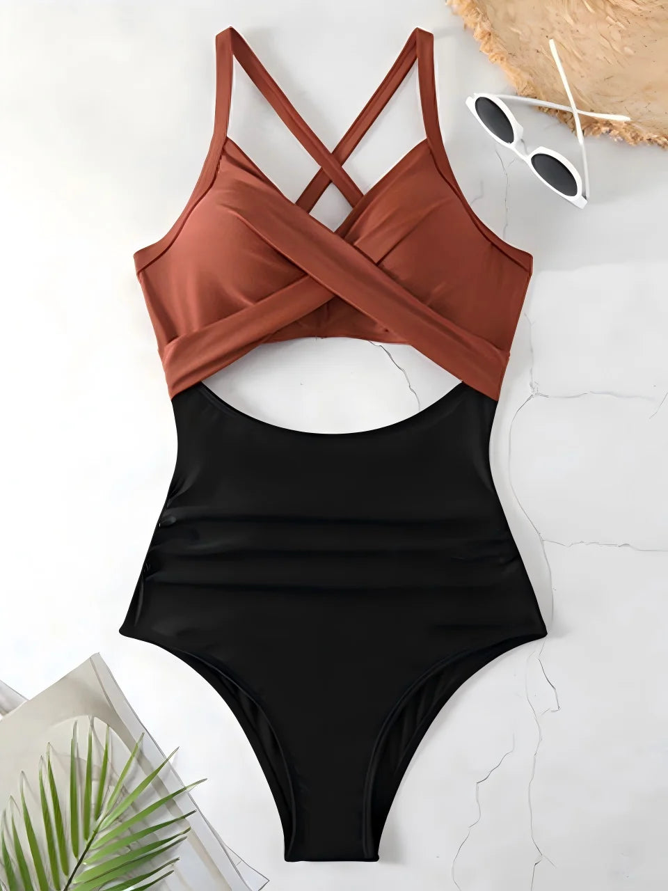 coffee brown cross strap top with black body ruched one piece swimsuit laid flat
