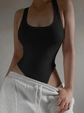 Black ribbed knit bodysuit on model, sleeveless bodycon fit over sweatpants