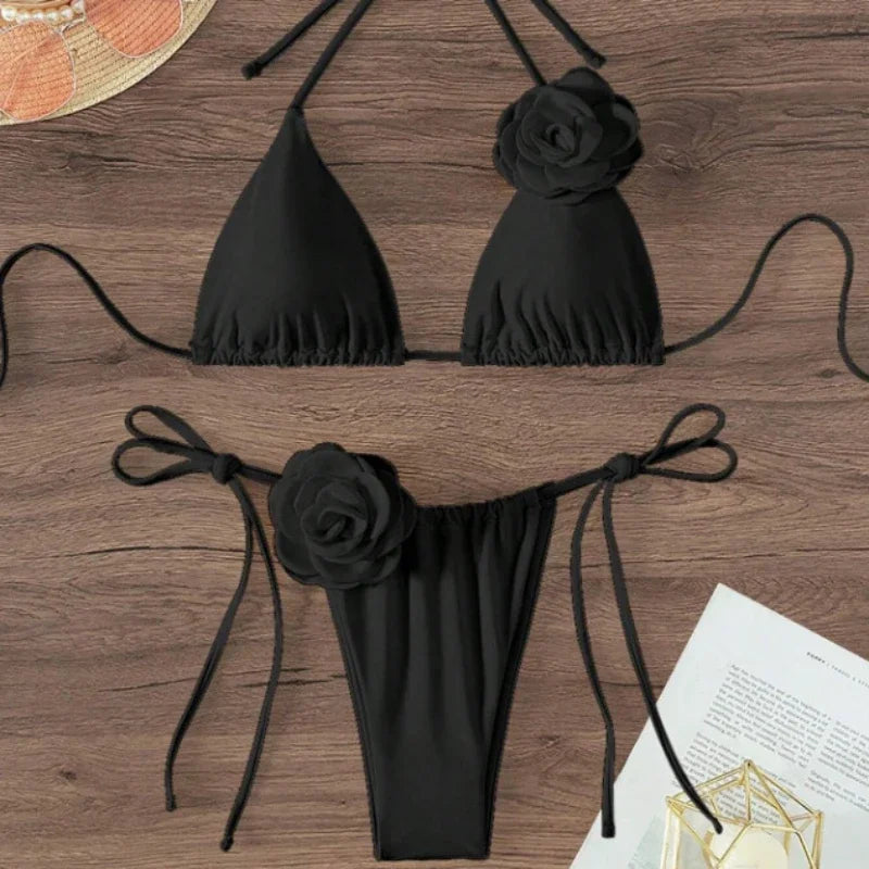 Black halter string bikini with 3D rose flower on the top and tie side bottom on wood