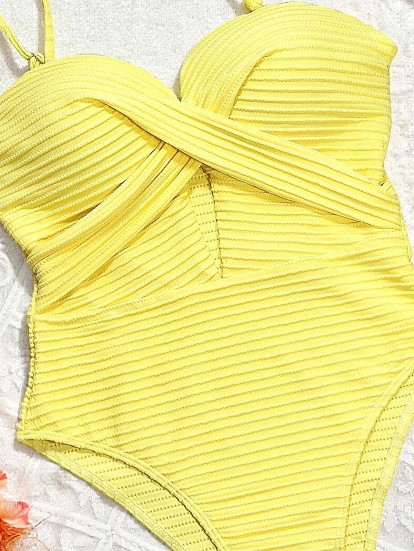 A vibrant yellow ribbed one-piece swimsuit with a sexy hollow-out cross tummy-control design and thin shoulder straps