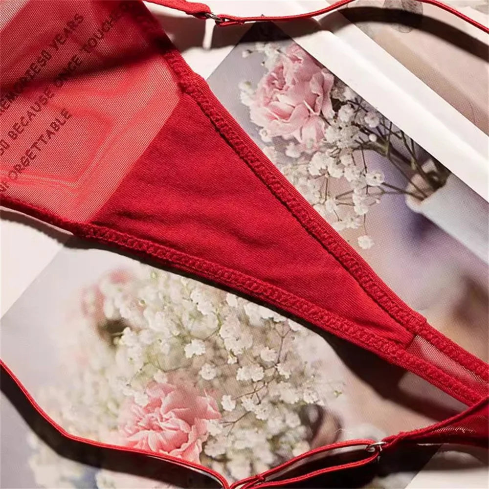 red sheer mesh thong on floral bed with printed gauze detail