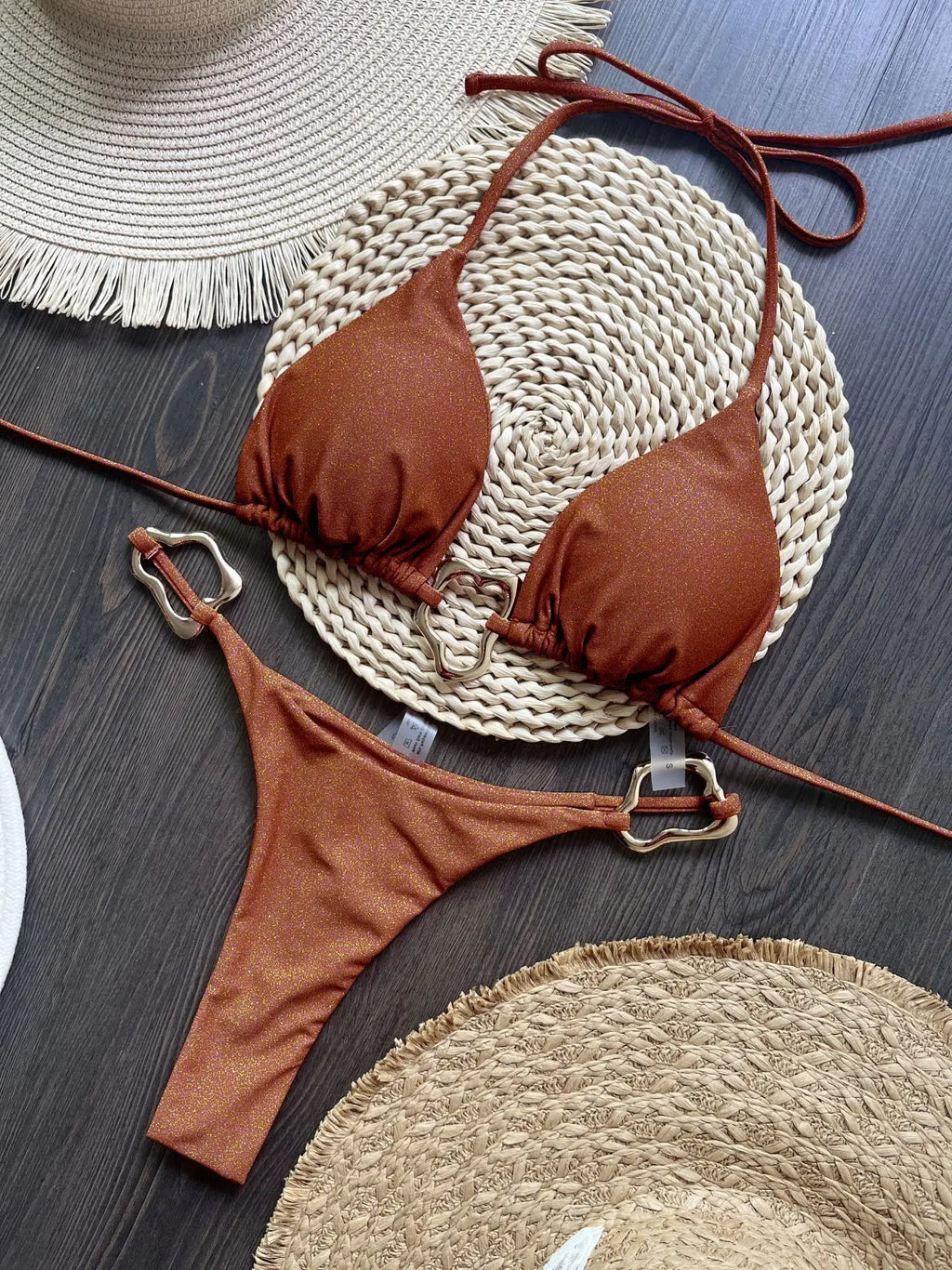 Brown halter micro bikini set with metal ring detail, flat lay