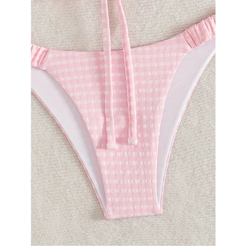 Detail of the pink gingham bikini bottom with a ruched waistband and high-cut leg