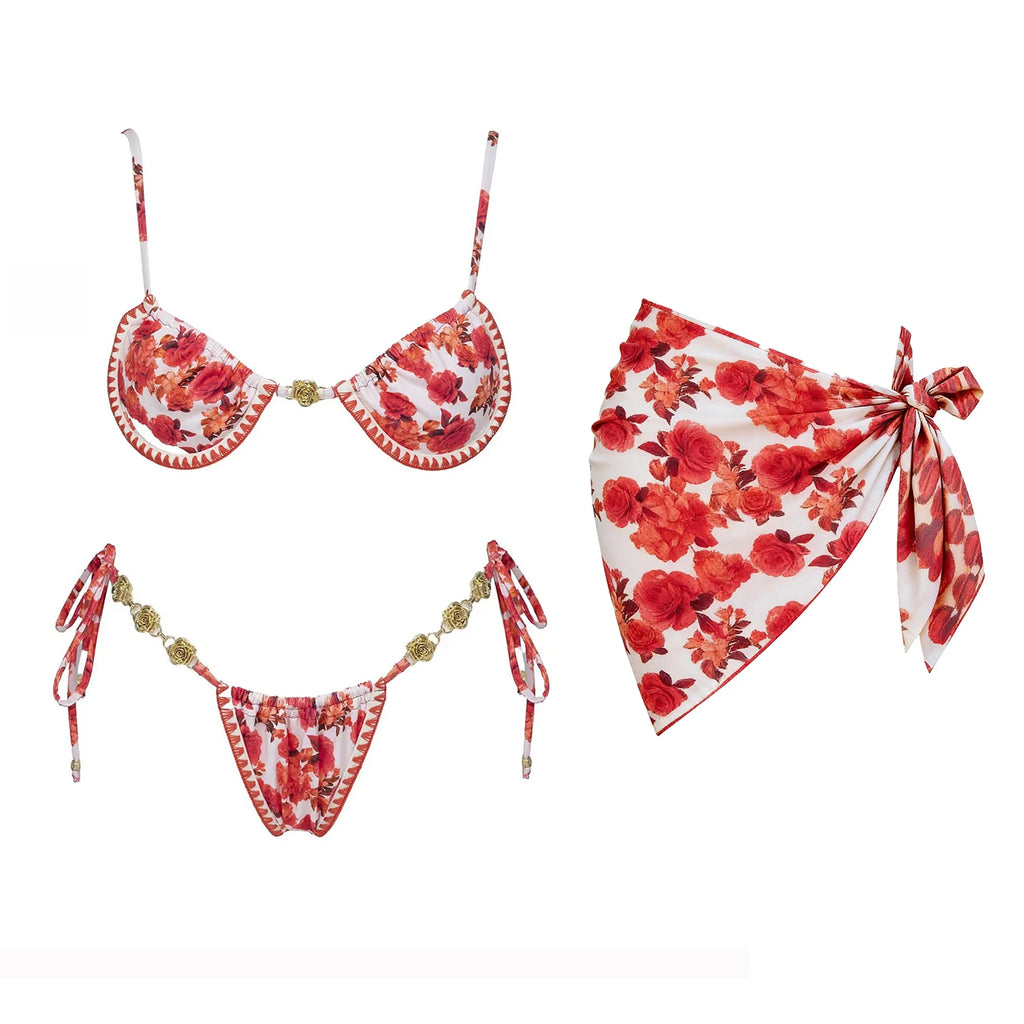 Strappy red floral micro bikini with hanging tie straps and floral sarong flat lay