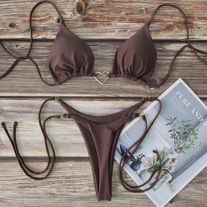 Brown halter triangle bikini set with gold heart clasp, flat lay