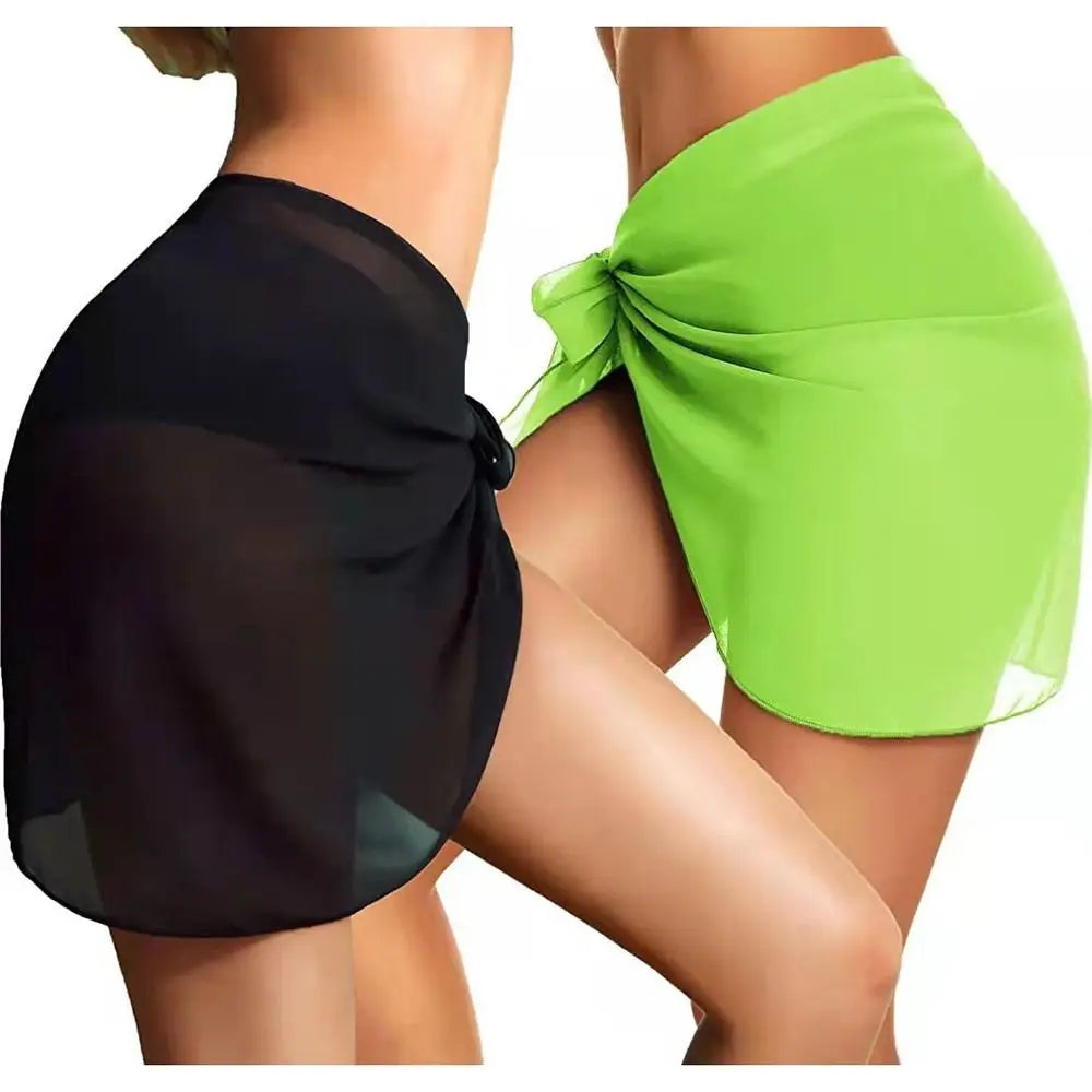 two models wearing black sheer and lime green chiffon sarong wraps tied at the hip