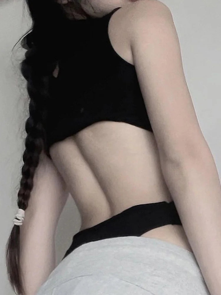 Back view of black cut out bodysuit with open back and mock neck panel