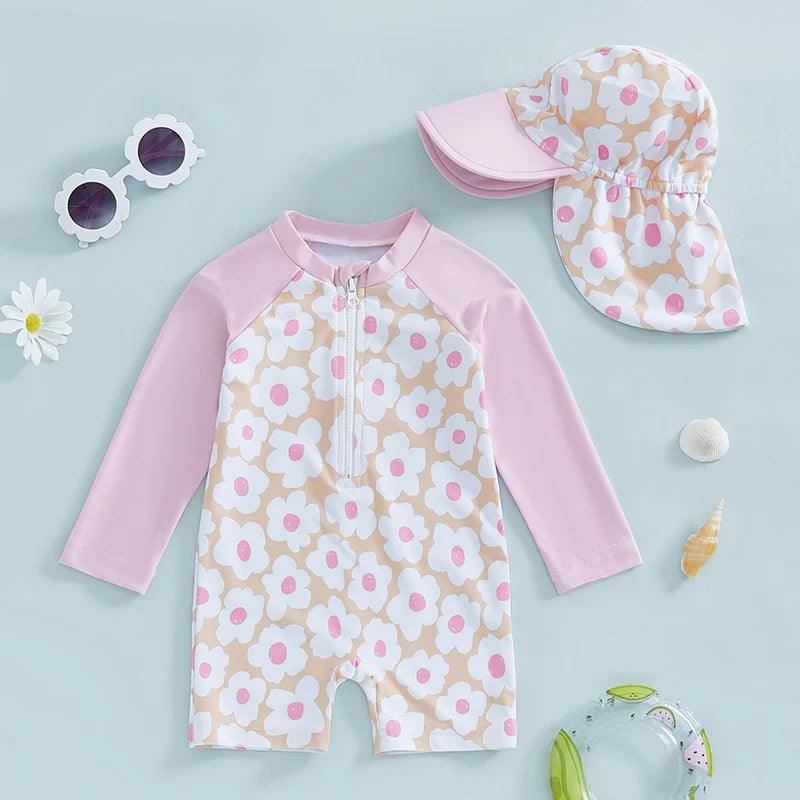 Toddler girls long-sleeve rash guard swimsuit set with pink and white floral pattern on beige background