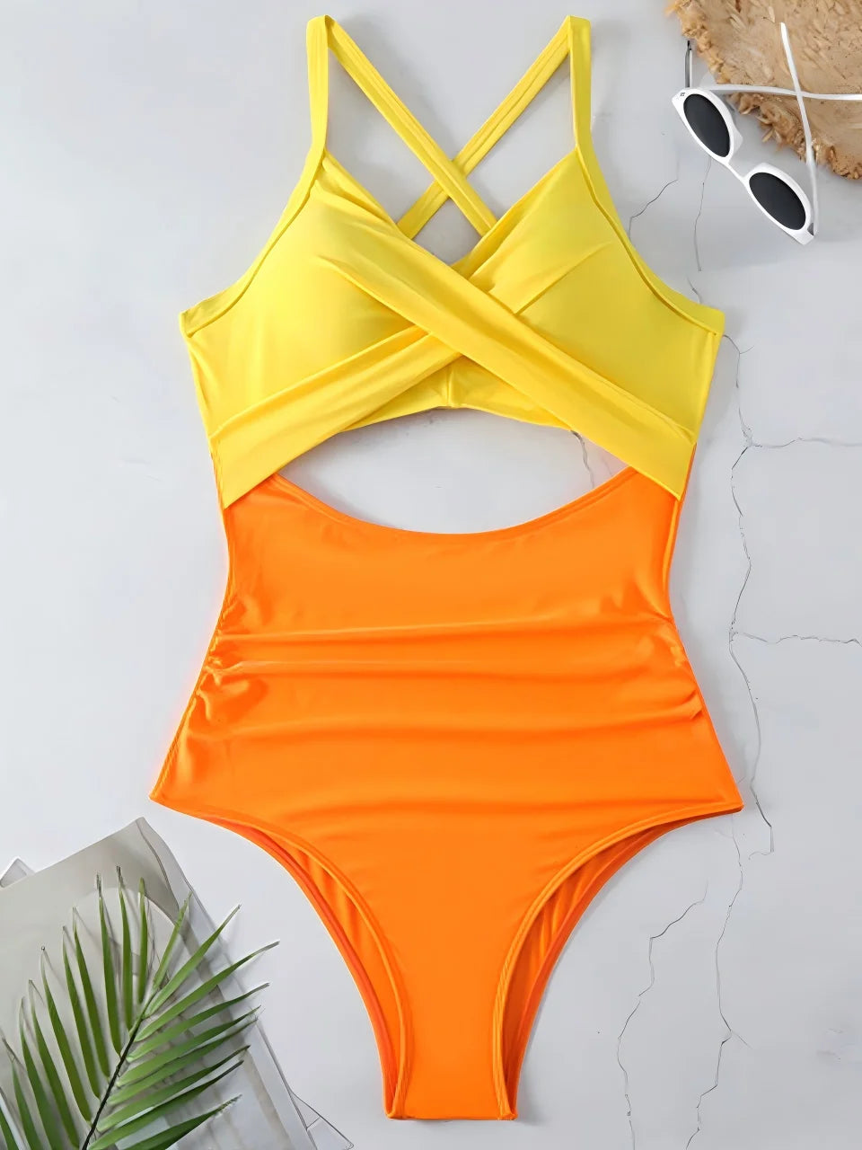 yellow cross strap top with orange body ruched one piece swimsuit laid flat
