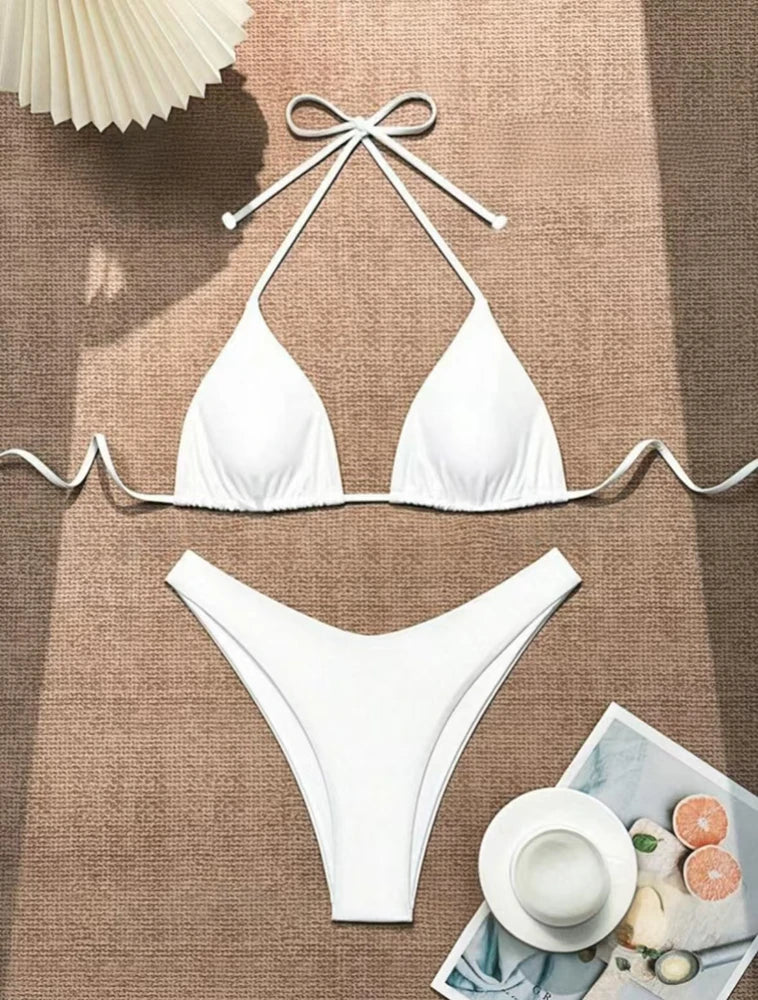 White ruffle halter bikini set with neck tie and high cut thong bottom on a burlap blanket