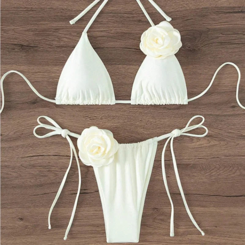 White halter string bikini with 3D rose flower on the top and tie side bottom on wood